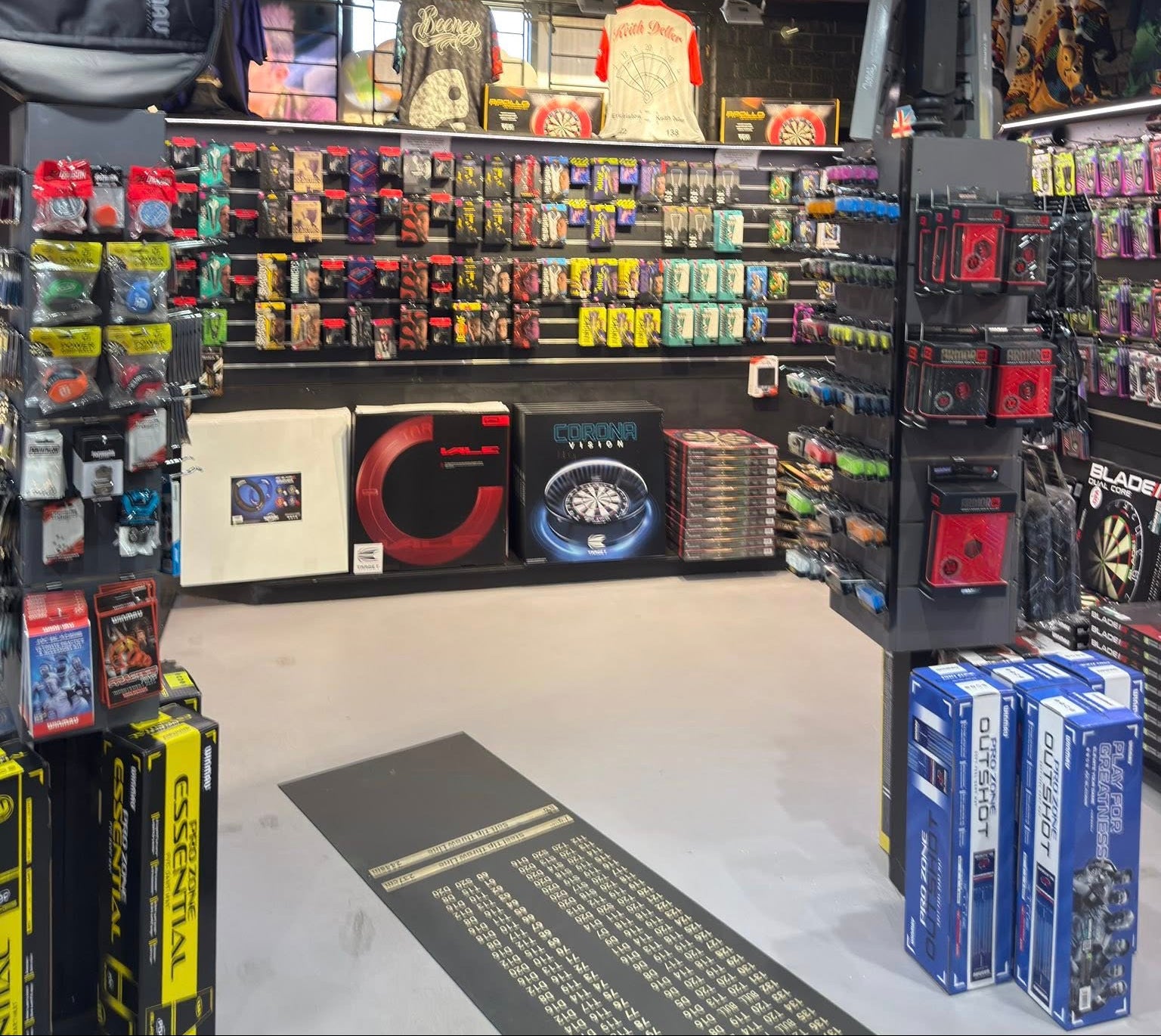 Store interior with shelves stocked with various products, including board games and collectibles.